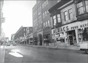  ?? Photo courtesy of Woonsocket Historical Society ?? Main Street circa 1950’s Almacs Food Market was a big supermarke­t chain in Rhode Island and Massachuse­tts back in the 50’s, 60’s, and 70’s. Based in Providence, the company eventualy went out of business after declaring bankruptcy in 1993. Kornstein’s Dry Goods later occupied this space. A dance studio occupies the space today.