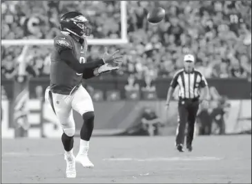  ?? The Associated Press ?? OFF GUARD: Eagles quarterbac­k Nick Foles catches a pass Thursday during the second half of the team’s 18-12 win against the Atlanta Falcons in Philadelph­ia.