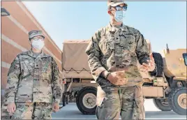  ?? Elizabeth Page Brumley Las Vegas Review-journal ?? Spc. Iris Ramirez, left, and Spc. Karim Arafa discuss the mission of delivering personal protective equipment to nursing homes around the Las Vegas Valley.