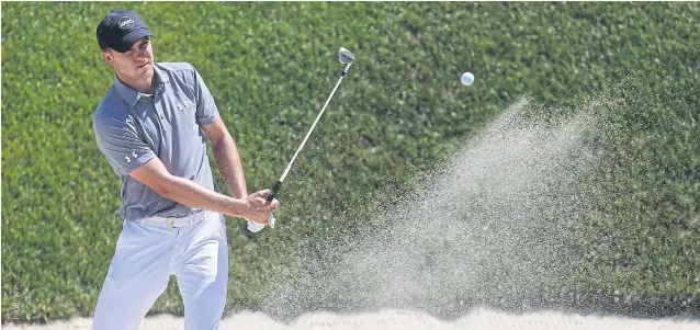  ??  ?? Jordan Spieth plays a bunker shot in the first round of the Travelers Championsh­ip.