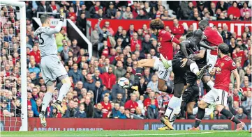  ??  ?? Air strike: Marouane Fellaini rises to score Manchester United’s second goal, and the first of his two, in the drubbing of Crystal Palace