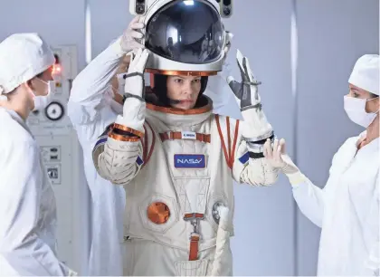  ?? DIYAH PERA/NETFLIX ?? Emma Green (Hilary Swank) suits up for a mission to Mars in Netflix’s “Away.”