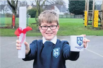  ??  ?? Pupil Hadleigh Spindley, nine, with mementos after children were the focus as William Gladstone C of E Primary Academy held a celebratio­n day to mark the change of its name to The King’s C of E Primary Academy. Children took part in a virtual meeting with staff, governors and members of the Diocese of Southwell and Nottingham Multi Academy Trust. Head teacher Sarah Clarke said: “The ceremony marks the start of a brand new chapter in the exciting story of our academy. We have come so far in such a short space of time and every day I see our Christian values of kindness, friendship and faith being lived out in the school community.” Children gave readings, performed The King’s Rap and heard from Nigel Frith (Diocesan Director Education) and Chris Moodie, CEO of the Diocese Southwell and Nottingham Multi Academy Trust. After the event children were given mementos of the day recognisin­g the new school name and logo, and also received a scroll containing a pledge from the school.