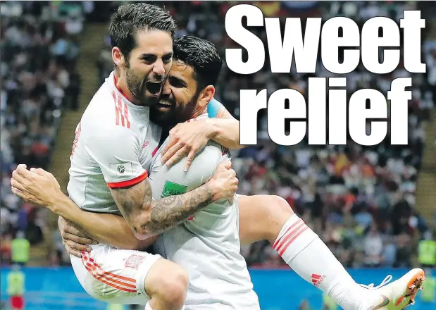  ?? — THE ASSOCIATED PRESS ?? Spain’s Diego Costa, right, celebrates with Isco after scoring the winning goal against Iran on Wednesday in Kazan, Russia.