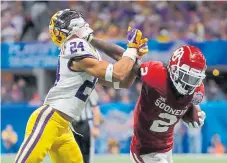  ?? Kevin C. Cox, Getty Images, Getty Images ?? Oklahoma wide receiver CeeDee Lamb, right, battling LSU’s Derek Stingley Jr. during a College Football Playoff semifinal, is in the hunt to be the Broncos’ first draft pick.