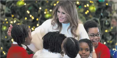  ?? Carolyn Kaster ?? The Associated Press First lady Melania Trump greets visiting children Monday at the White House. The first lady chose Christmas decor that honors 200 years of holiday traditions at the White House.