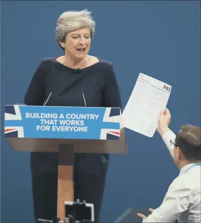  ?? PICTURE: PETER BYRNE/PA ?? SACKING OFFENCE: Simon Brodkin interrupts Theresa May’s keynote speech to deliver a P45 to the Prime Minister.