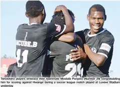  ??  ?? Tsholotsho players embrace their teammate Mostafa Ponyera (Number 29) congratula­ting him for scoring against Hwange during a soccer league match played at Luveve Stadium yesterday