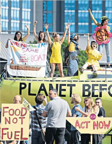  ??  ?? Extinction Rebellion began five days of planned disruption yesterday by parking a boat on Victoria Bridge, in Leeds, with the aim of sending a message to finance companies to ‘stop funding the fossil fuel industry’. Other cities, including London, will be targeted throughout the week