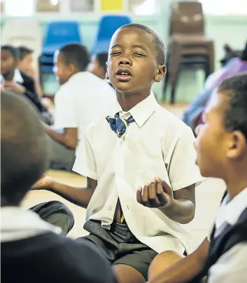  ?? Picture: Clare Louise Thomas ?? Akim May, a pupil at Sentinel Primary in Hout Bay, seeks calm during a group meditation session.