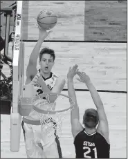  ?? AP/DAVID J. PHILLIP ?? Gonzaga forward Zach Collins shoots over South Carolina forward Maik Kotsar. Collins finished with 14 points, 13 rebounds and 6 blocks for the Bulldogs.