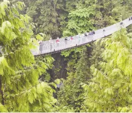  ?? JONATHAN HAYWARD / THE CANADIAN PRESS FILES ?? The Capilano Suspension Bridge, which crosses the Capilano River in North Vancouver,
remains closed as a result of COVID-19 restrictio­ns.