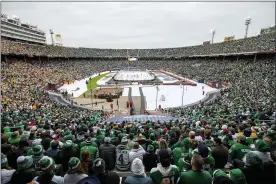  ?? JEFFREY MCWHORTER — THE ASSOCIATED PRESS FILE ?? In this Jan. 1, 2020, file photo, fans watch the NHL Winter Classic hockey game between the Dallas Stars and the Nashville Predators at the Cotton Bowl in Dallas. Outdoor games have become the marquee event of the NHL season ever since the league staged the first Winter Classic in Buffalo in 2008. None of the 30previous outdoor games had quite a setup like this season when the league will stage two games this weekend on the 18th fairway of a golf course on the shores of Lake Tahoe, with the Sierra Nevada Mountains towering in the background.