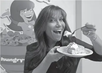  ?? AP PHOTO ?? Hungry Girl Lisa Lillien poses in her office in the Woodland Hills area of Los Angeles. The controveri­sal food maven tells people how to eat their cake and keep their weight down too.