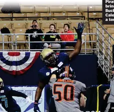  ??  ?? Pirates defenders bring pressure as Bucks quarterbac­k Caleb Lewis looks for a touchdown pass.