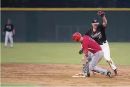  ?? Staff photo by Evan Lewis ?? Texarkana Twins second baseman Kyle Bottger makes the catch just behind Acadiana's Trey Morgan in the fourth inning of Wednesday night's game at George Dobson Field. The score was tied as of presstime.