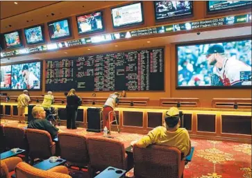  ?? JOHN LOCHER Associated Press ?? PEOPLE make bets at the South Point Hotel in Las Vegas. The Supreme Court cleared the way for states to legalize sports betting in 2018, but California has yet to do so. The state has been stalled by political squabbles.