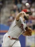  ?? FRANK FRANKLIN II — THE ASSOCIATED PRESS ?? Phillies starter Jake Arrieta delivers during the first inning against the Mets Saturday, an outing that lasted 4.1 rocky innings. The reason for Arrieta’s recent struggles, it was revealed Sunday, is a bone spur in his elbow.