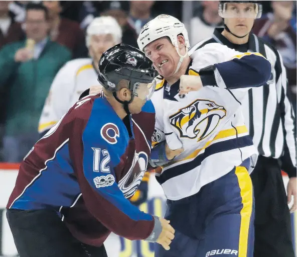  ?? — THE ASSOCIATED PRESS FILES ?? Nashville Predators winger Cody McLeod throws a punch at former Colorado Avalanche teammate Jarome Iginla during Saturday’s game. McLeod and the Predators take on the Canucks at Rogers Arena on Tuesday night.