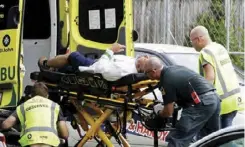  ??  ?? Ambulance staff take a man from outside a mosque in central Christchur­ch, New Zealand
