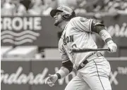  ?? Chris Young / The Canadian Press via AP ?? Yuli Gurriel watches the flight of his second-inning solo homer, which started the Astros on the way to their lopsided win at Rogers Centre.