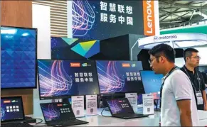  ?? PROVIDED TO CHINA DAILY ?? A visitor looks at Lenovo products at CES Asia 2018 in Shanghai on June 14.