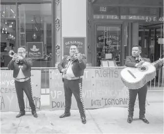  ?? THE ASSOCIATED PRESS ?? The Mariachi Tapatio de Alvaro Paulino band performs during a demonstrat­ion across the street from the building that once housed the office of Aaron Schlossber­g in New York on Friday.