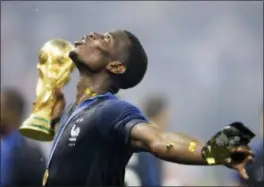  ?? NATACHA PISARENKO - THE ASSOCIATED PRESS ?? France’s Paul Pogba celebrates with the trophy after the final match between France and Croatia at the 2018 World Cup in the Luzhniki Stadium in Moscow, Russia.