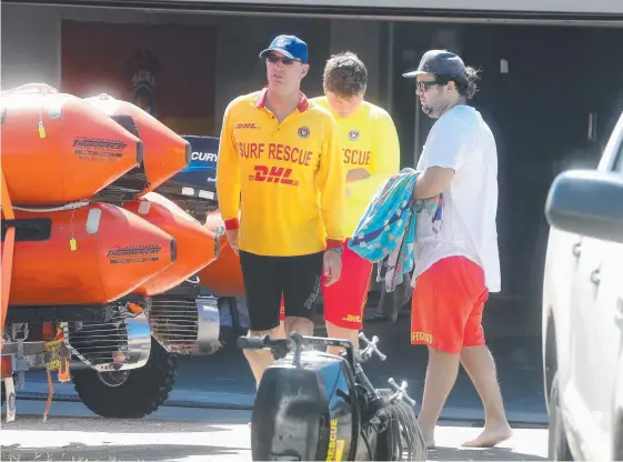  ??  ?? Members at the Fingal SLSC back on shore after the harrowing search for the missing bodyboarde­r.. Pictures: RICHARD GOSLING