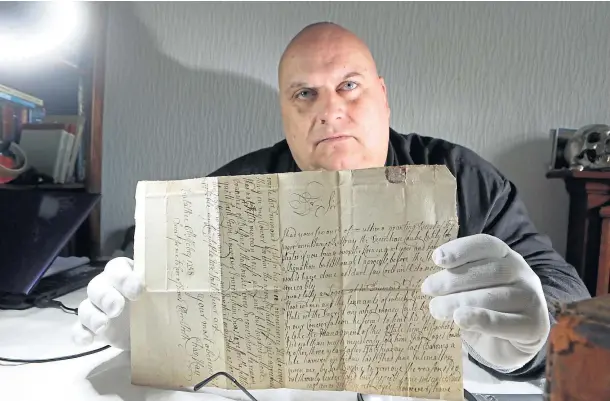  ??  ?? DEATH SENTENCE: Historian Lenny Low with a manuscript showing an execution order for James Rattray from 1758. Picture by Gareth Jennings.