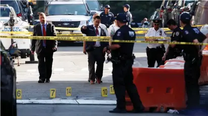  ?? (Reuters) ?? NYPD OFFICERS work near a police vehicle where a man fatally shot a female officer in the Bronx yesterday.