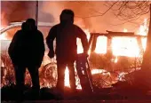  ??  ?? Mayhem: Rioters burn cars in Stockholm