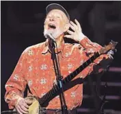  ?? Timothy A. Clary
Afp/getty Images ?? PETE SEEGER performs at a concert to mark his 90th birthday at Madison Square Garden in 2009.