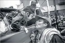  ??  ?? A MOTHER talks to her son after he recited some words for supporters of Maduro. The boy is dressed as Simon Bolivar, the hero of independen­ce for Venezuela and an inspiratio­n for late President Hugo Chavez’s “Bolivarian revolution.”