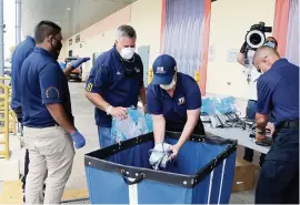  ?? PEDRO PORTAL pportal@miamiheral­d.com ?? FIU staff members Javier Marquez, second from left, vice president and chief of staff, and Bridget Pelaez, center, FIU’s assistant director for emergency management, load ventilator­s that the university gave to the state of Florida to be used to treat patients affected by the COVID-19 outbreak on April 8.