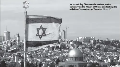  ?? Photo: IC ?? An Israeli flag flies near the ancient Jewish cemetery on the Mount of Olives overlookin­g the old city of Jerusalem, on Tuesday.