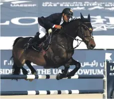  ??  ?? Ramzy Al Duhami of Saudi Arabia guides his horse, Ted, to first place in the President of the UAE Cup at Al Forsan