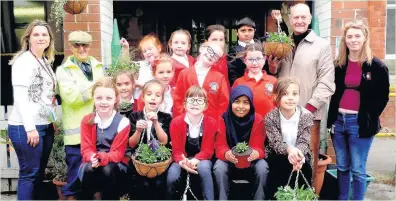  ??  ?? Pictured are members of Cobden Gardening Club with their finished hanging baskets and pots. Barbara Kormos and Harry Cook stand on the far left, and Mike Jones and Jane Squires on the far right.