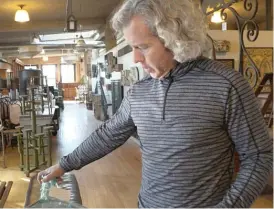  ?? NADER ISSA/SUN-TIMES ?? Architectu­ral Artifacts owner Stuart Grannen shows off some of the antiques in his 30,000-square-foot showroom in Ravenswood.