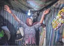  ?? [MULUGETA AYENE/ THE ASSOCIATED PRESS] ?? Mother of two Amsale Hailemaria­m, a domestic worker who lost work because of the coronaviru­s, stands in her small tent June 26 in Addis Ababa, Ethiopia.