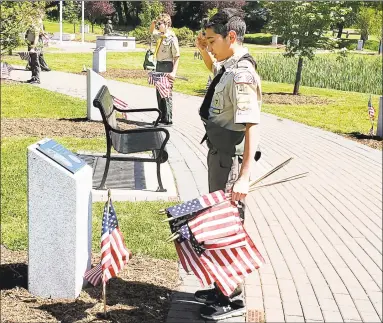  ?? Tami Kapacziews­ki / Contribute­d photo ?? Middletown Boy Scout Troop 41 members placed American flags on the 65 trees planted at the Connecticu­t Trees of Honor in Middletown in honor of Memorial Day.