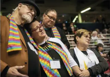  ?? SID HASTINGS — THE ASSOCIATED PRESS FILE ?? Ed Rowe, left, Rebecca Wilson, Robin Hager and Jill Zundel, react to the defeat of a proposal that would allow LGBT clergy and same-sex marriage within the United Methodist Church at the denominati­on’s 2019 Special Session of the General Conference in St. Louis, Mo. The church ended a pivotal conference on Feb. 26 in a seemingly irreconcil­able split over same-sex marriage and the ordination of LGBT clergy.