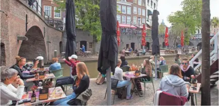  ?? PETER DEJONG/AP ?? Dutch customers eager for their first drinks have flocked to outdoor seating as the Netherland­s’ lockdown eased in Utrecht April 28. The Netherland­s began relaxing lockdown even as infection rates and hospitaliz­ations remain high.