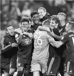  ??  ?? Bayern Munich’s Austrian defender David Alaba (second left) celebrates with his teammates after winning the penalty shoot out during the German Cup match against RB Leipzig in Leipzig, eastern Germany. — AFP photo