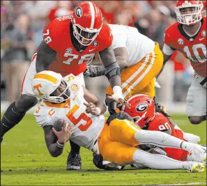  ?? John Bazemore
The Associated Press ?? Tennessee QB Hendon Hooker (5) is sacked by Georgia defensive linemen Tramel Walthour (90) and Nazir Stackhouse (78) Saturday.