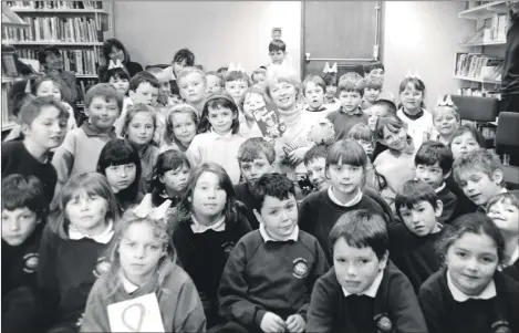  ?? 01_B10twe03 ?? A healthy gathering of children from Arran villages visited the Brodick Library to meet with author Margaret Ryan who wrote The Littlest Dragon.