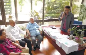  ?? CONTRIBUTE­D FOTO ?? PUSHING BACK. Opposition lawmakers (from left) Ifugao Teddy Baguilat, Magdalo Rep. Gary Alejano, and Albay Rep. Edcel Lagman file an impeachmen­t complaint against seven justices.