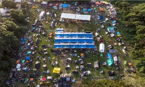  ??  ?? Aerial view of a temporary shelter for Honduran migrants, taking part in a caravan heading to the US, set up at a football field in Matias Romero, Oaxaca State, Mexico. — AFP photo