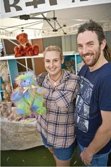  ??  ?? Emmaline Bassingthw­aighte buys a handmade toy bear with Steven Craige at the Cobb and Co Museum.