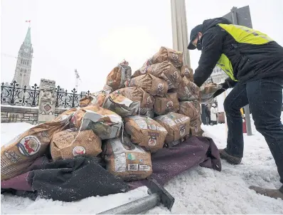  ?? ADRIAN WYLD THE CANADIAN PRESS FILE PHOTO ?? Bags of P.E.I. potatoes are piled outside Parliament last month after Agricultur­e Minister Marie-Claude Bibeau declared the province “infested” with potato wart and suspended potato shipments to the U.S. after the fungus was found in two fields.